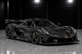 Koenigsegg Jesko in exposed carbon fibre displayed in a luxury automotive studio